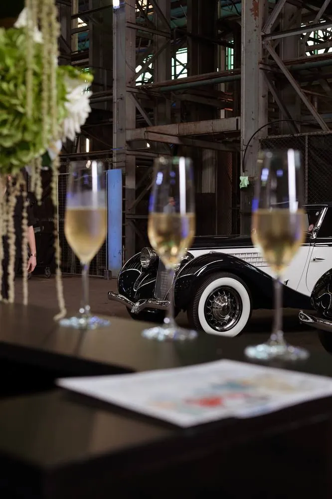 Champagne glasses with a vintage car in the background