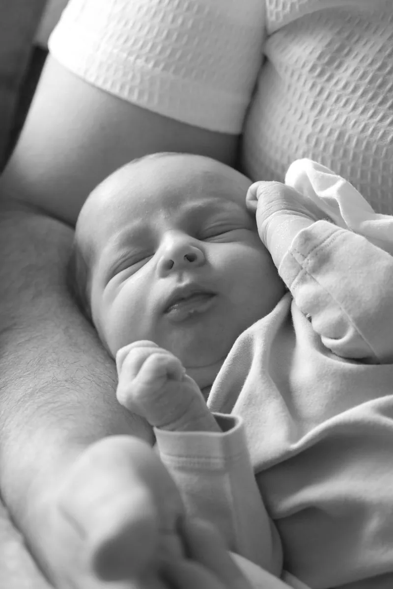 Close-up of a sleeping newborn, black and white