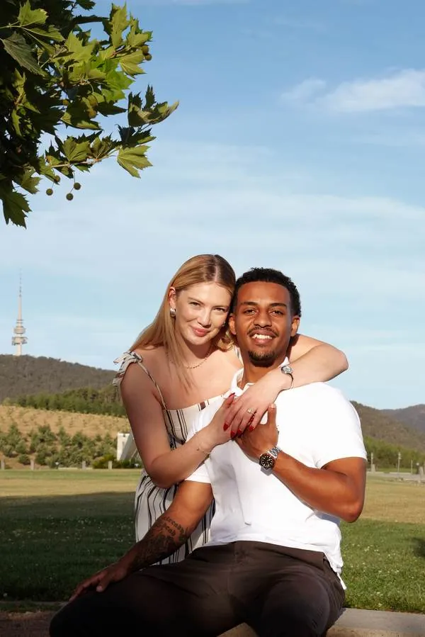 Couple embracing and smiling outdoors