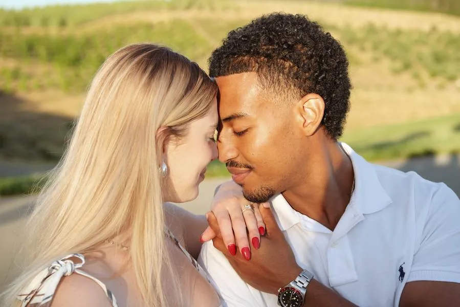 Couple sharing a forehead touch in natural light