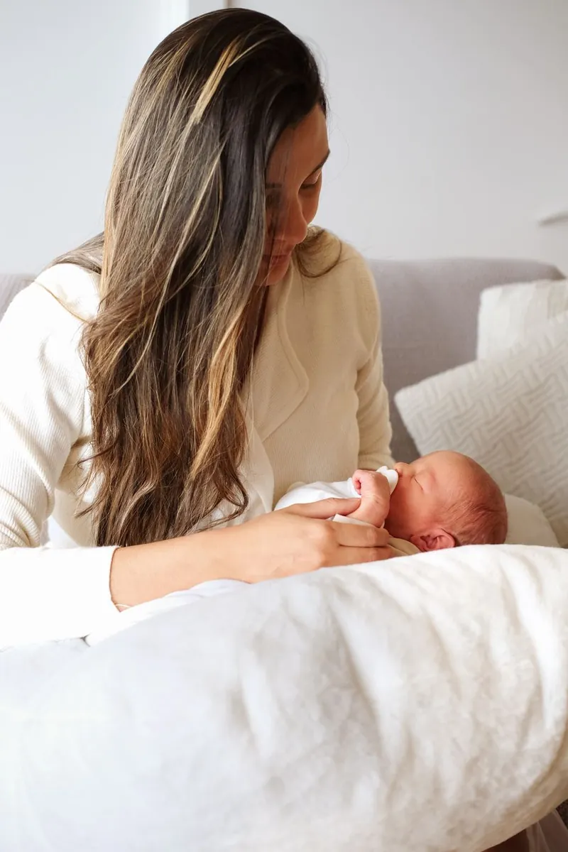Mother gazing down at her newborn
