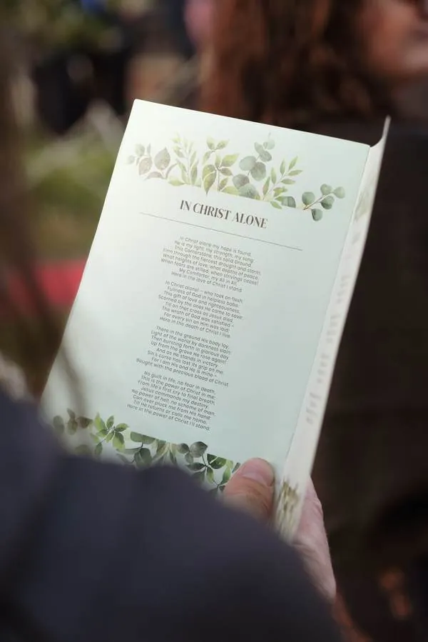Wedding ceremony program detail in natural light