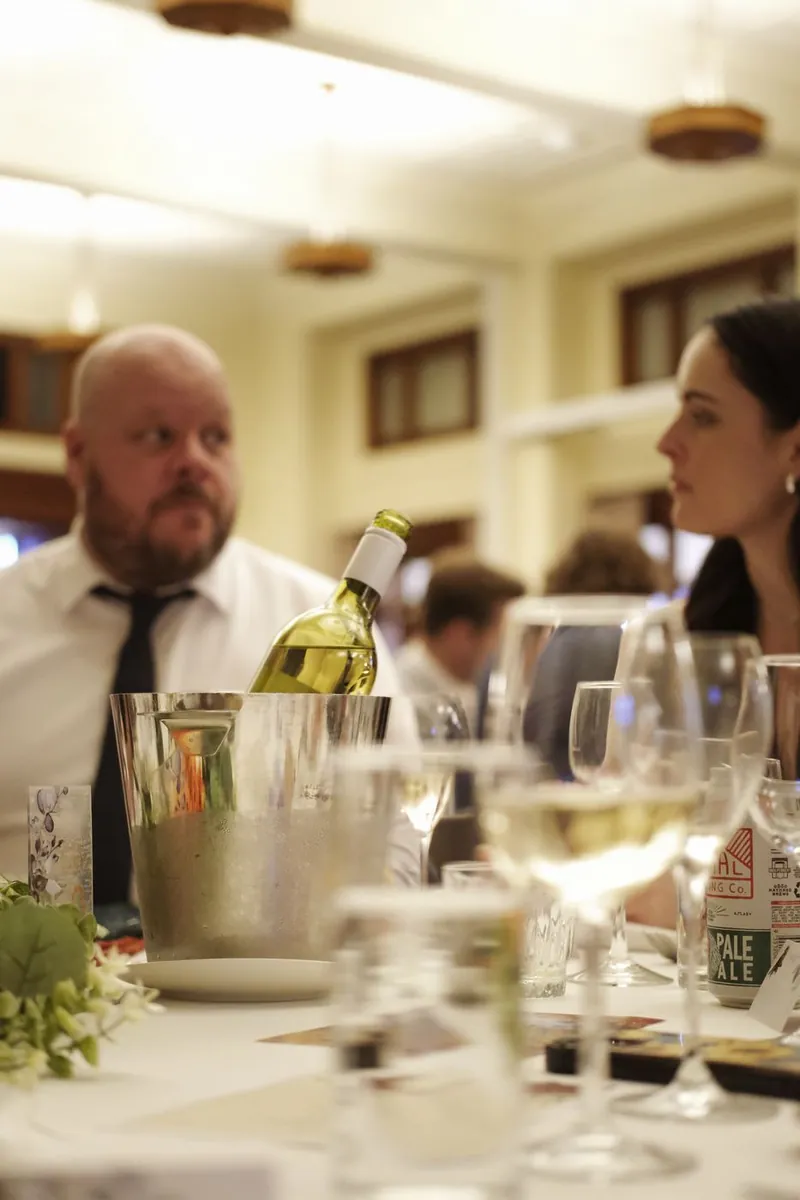 Wine bottle chilling in an ice bucket at the reception table
